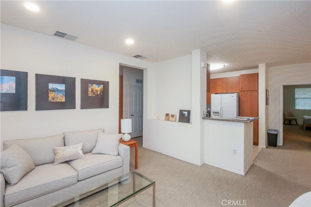 825 Francesca Drive, Unit 202 Walnut, CA 91789 - Photo 3 of 8 a living room with furniture and a flat screen tv