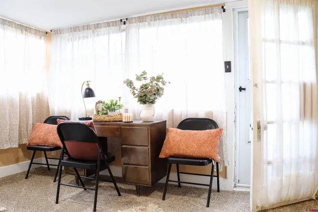 a dining room with furniture and window