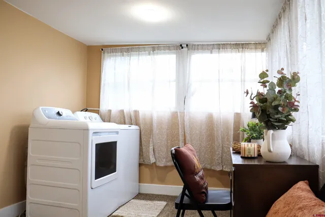 a utility room with cabinets washer and dryer
