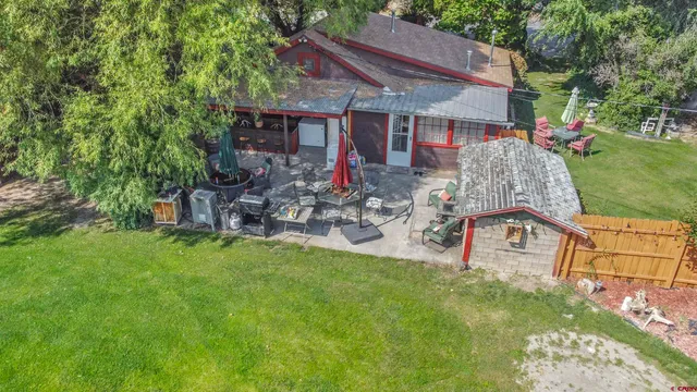 a view of a patio with table and chairs under an umbrella