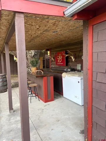 a view of a house with a big yard and a fountain