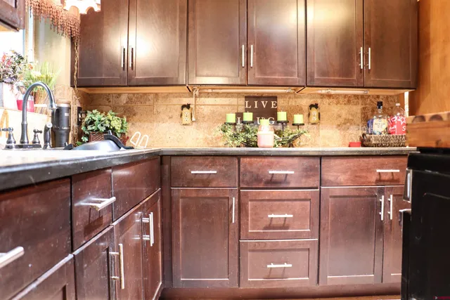 a kitchen with a refrigerator and cabinets
