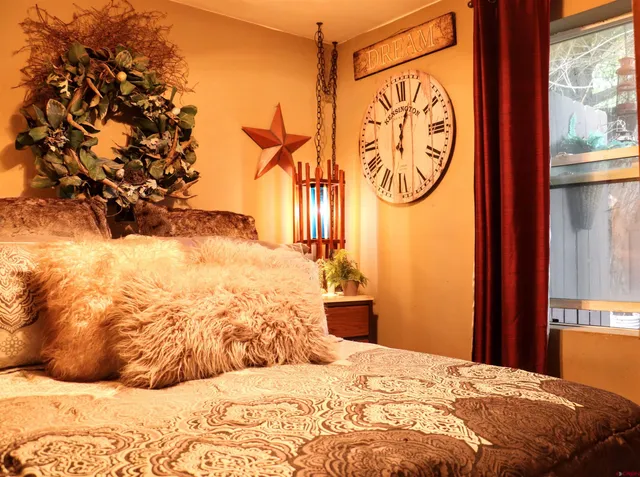 a bedroom with a bed and a chandelier