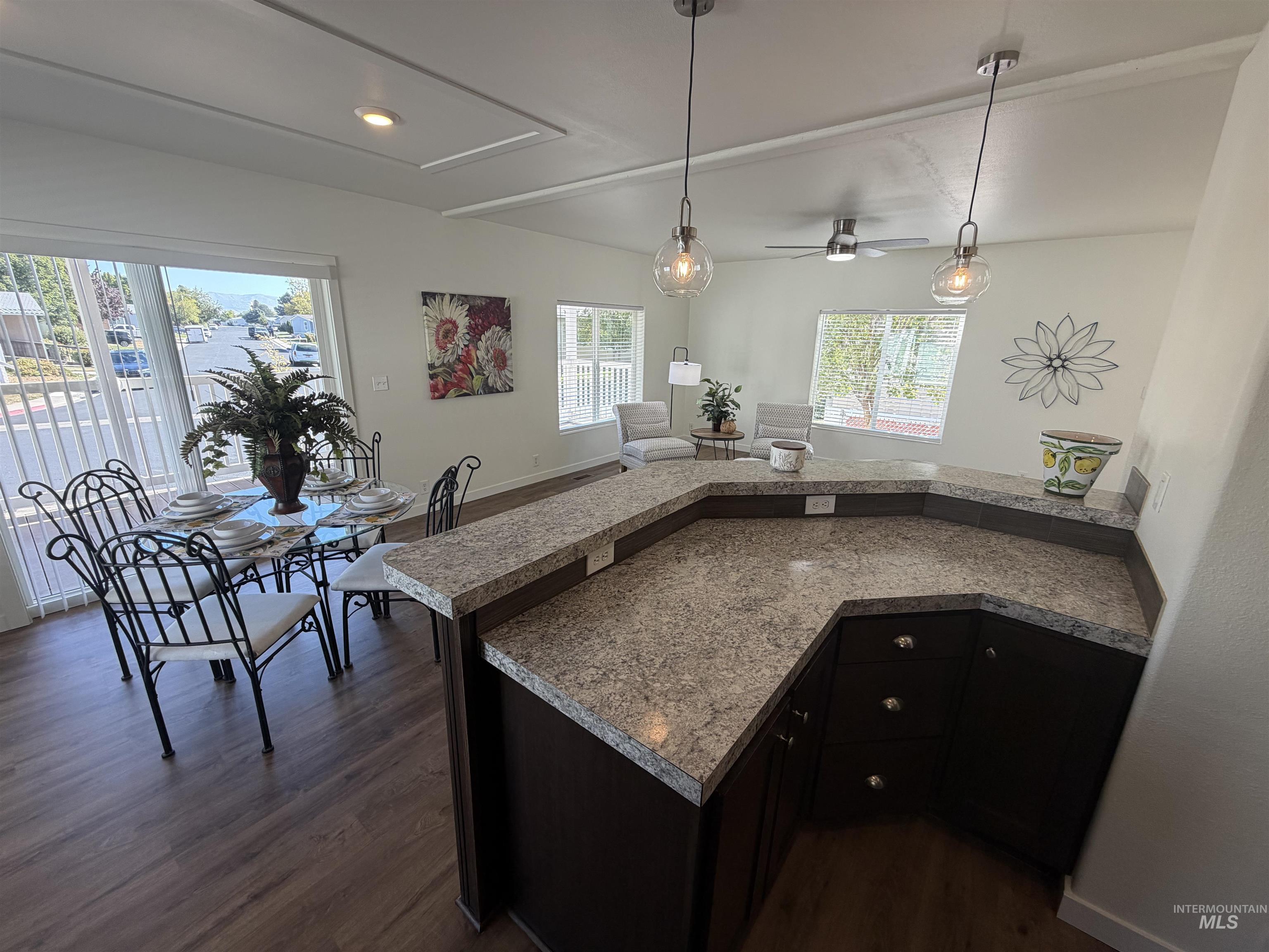 611 North Timathy Road Boise, ID 83713 - Photo 13 of 28 Wraparound kitchen counter with undermount cabinetry, wood-finish flooring, and recessed ceiling lighting
