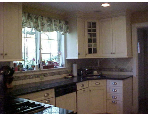 47 Palmer Road Newton, MA 02468 - Photo 3 of 8 a kitchen with granite countertop a stove a sink and a window