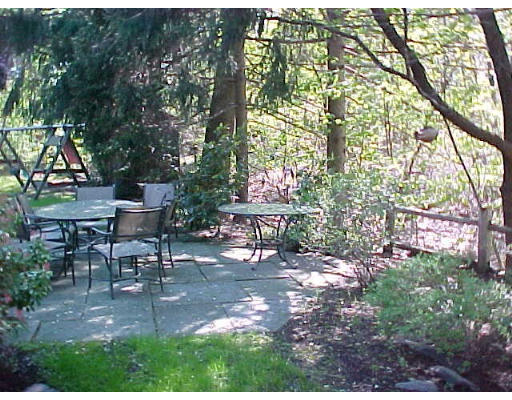 47 Palmer Road Newton, MA 02468 - Photo 8 of 8 a view of a patio with table and chairs under an umbrella