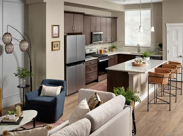 a living room with furniture kitchen view and a potted plant