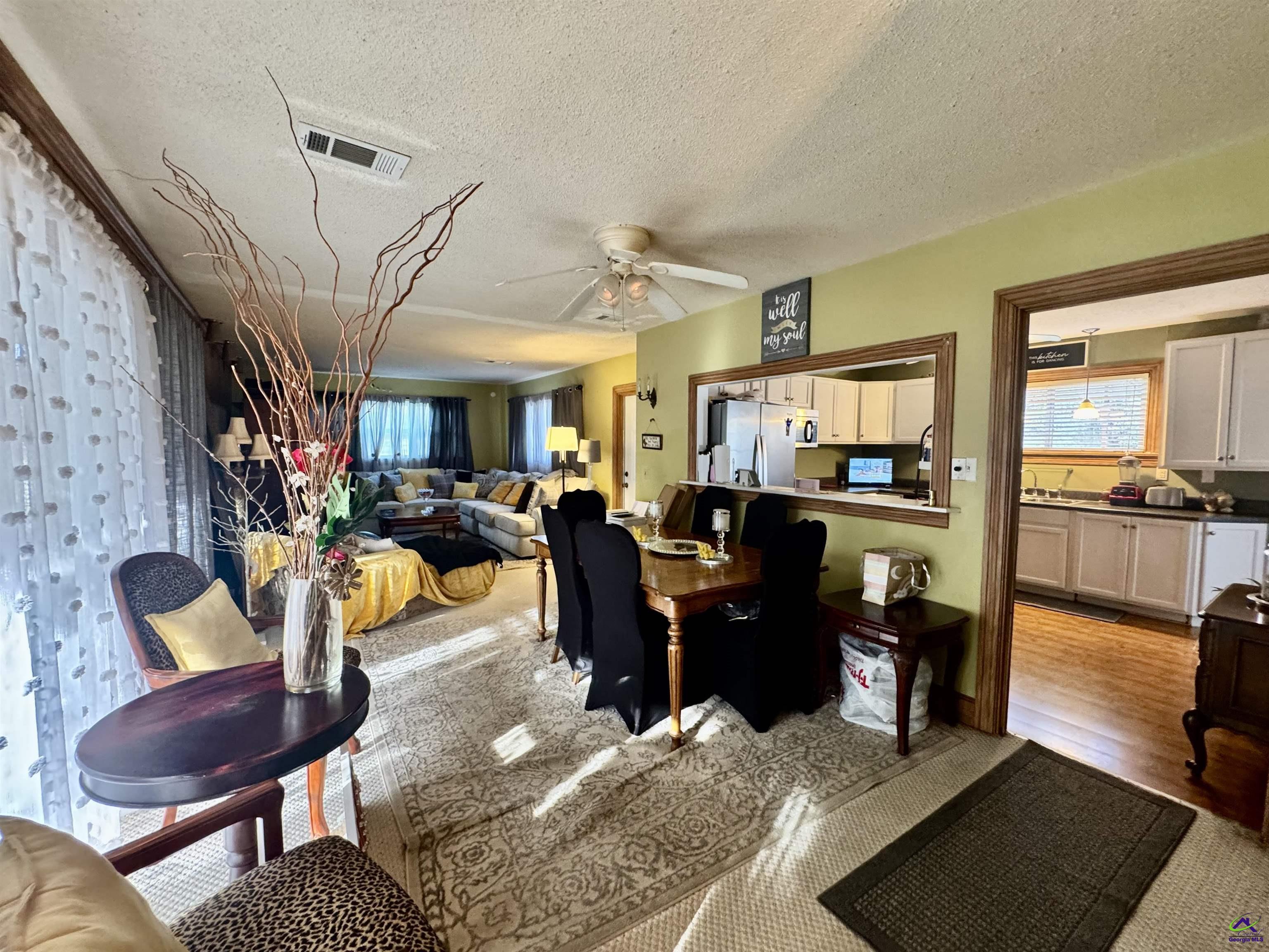 914 Adderton Street Americus, GA 31719 - Photo 14 of 53 a living room with furniture kitchen view and a wooden floor