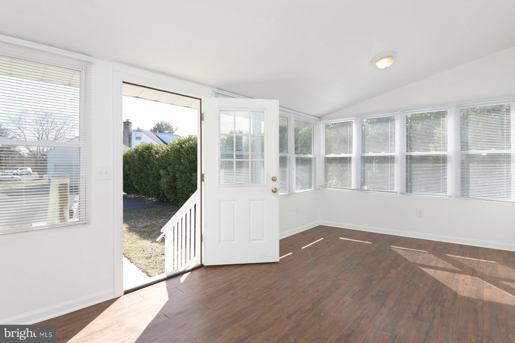 1740 Prospect Street Ewing, NJ 08638 - Photo 4 of 26 a view of an empty room with wooden floor and windows