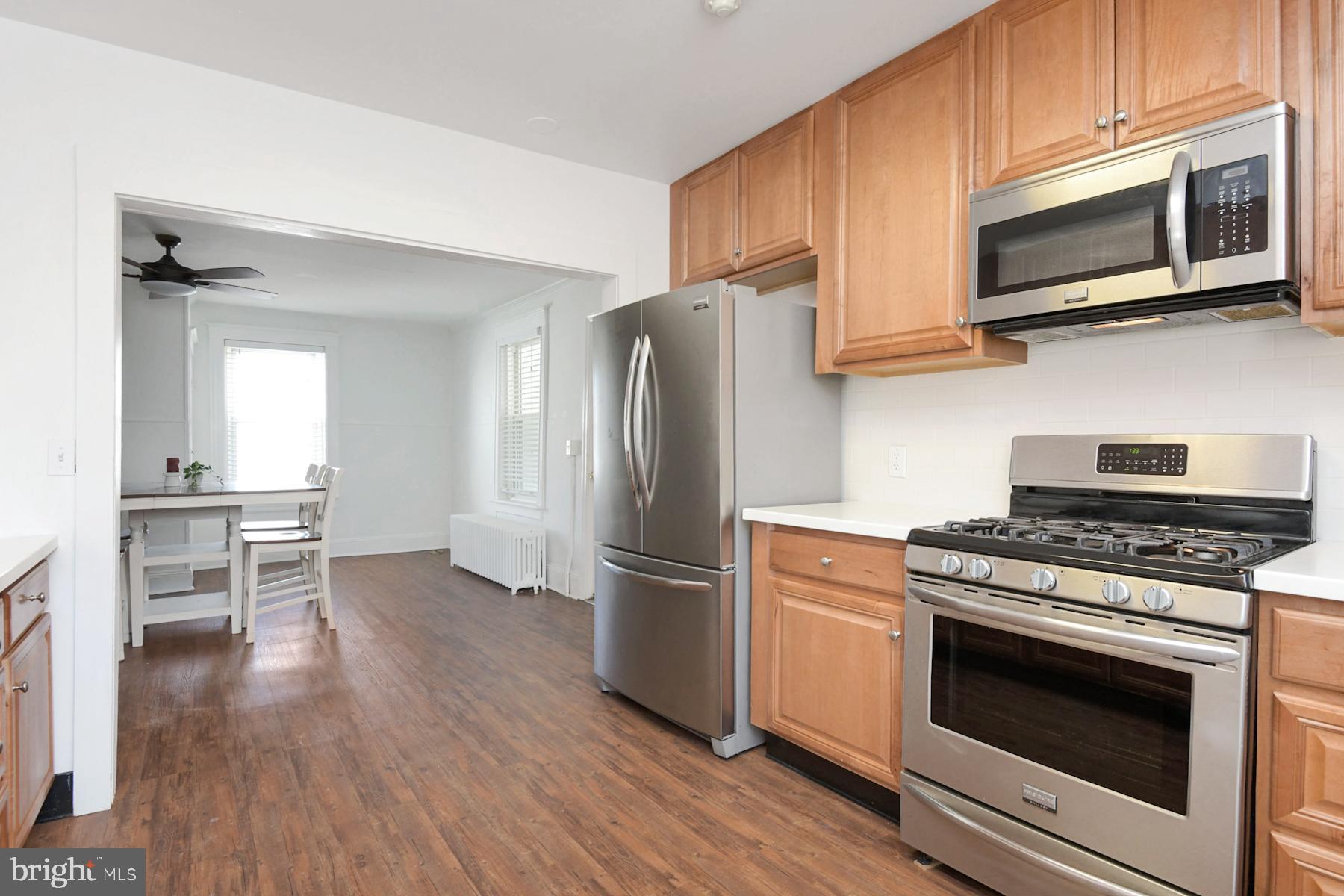 1740 Prospect Street Ewing, NJ 08638 - Photo 5 of 26 a kitchen with a stove a microwave and wooden floor