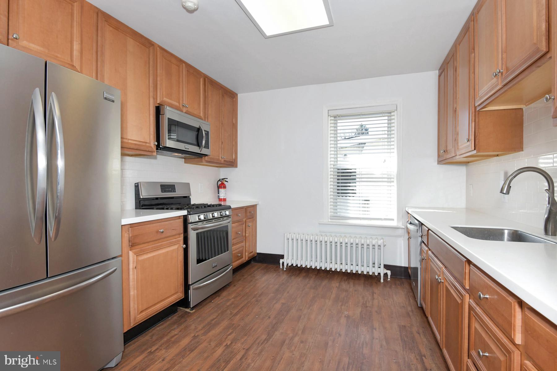 1740 Prospect Street Ewing, NJ 08638 - Photo 6 of 26 a kitchen with stainless steel appliances white cabinets a sink and a window
