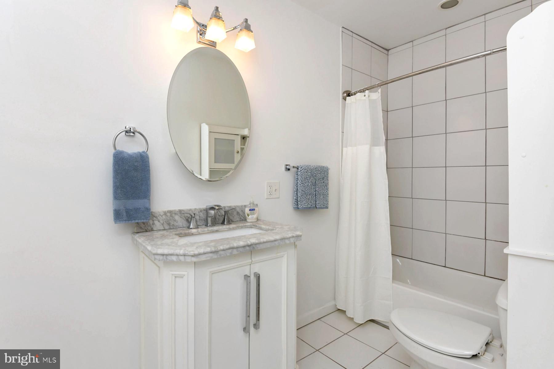 1740 Prospect Street Ewing, NJ 08638 - Photo 10 of 26 a bathroom with a sink a toilet and shower