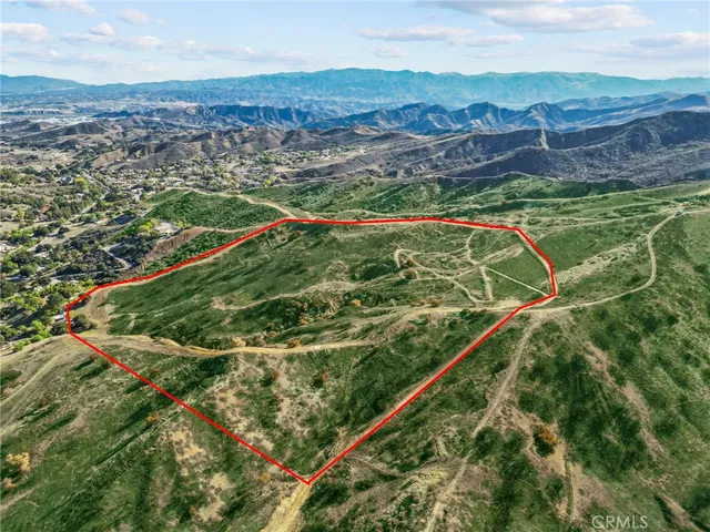 a view of a lush green hillside and a houses