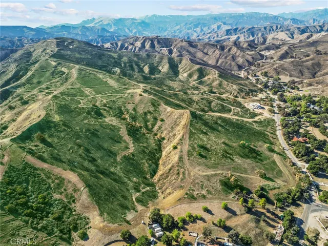 a view of a lush green hillside and a building