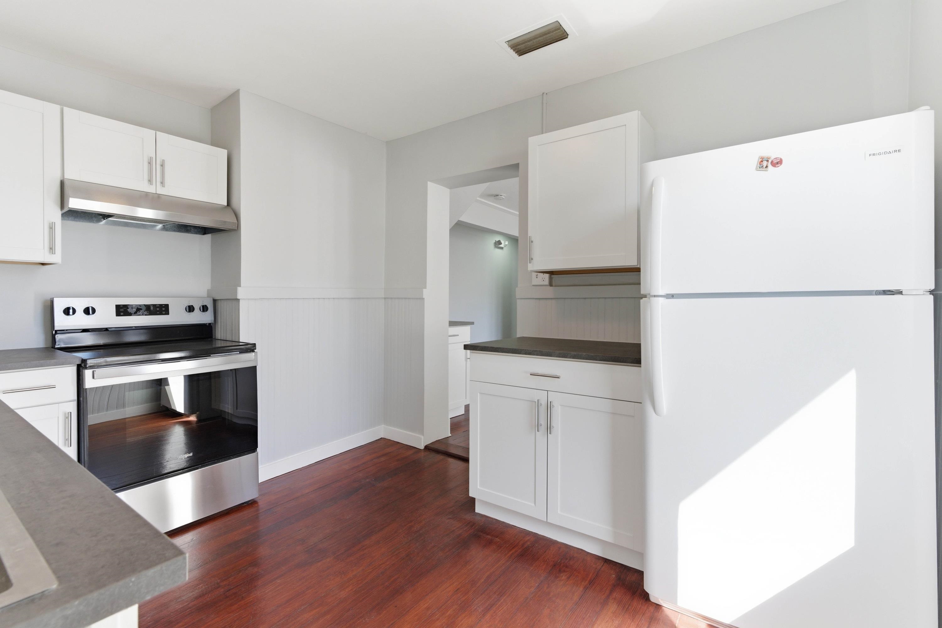 50 Saragossa Street, Unit D St. Augustine, FL 32084 - Photo 3 of 9 a kitchen with a refrigerator and a stove top oven