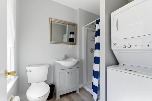 a bathroom with a toilet sink and mirror