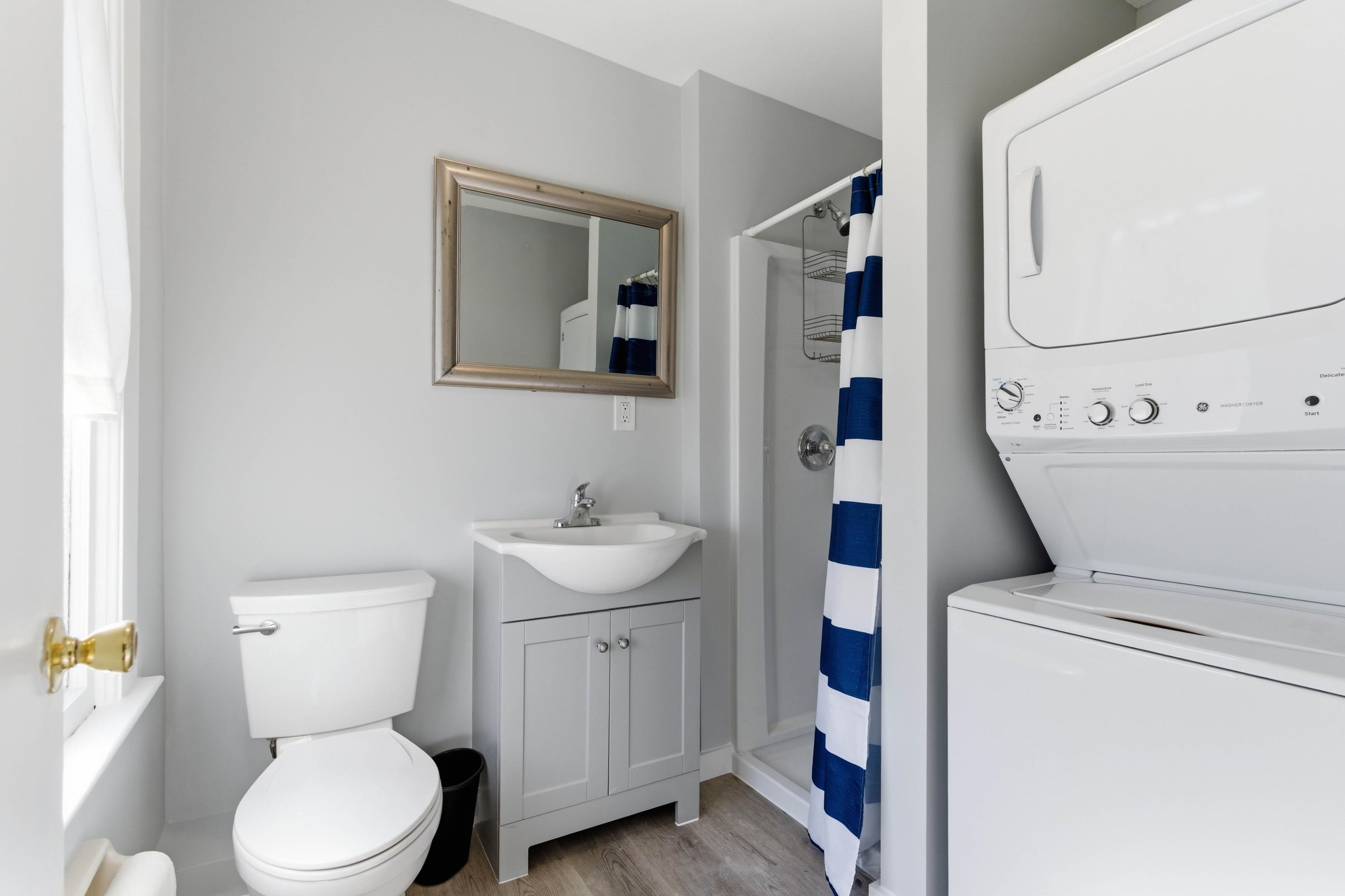50 Saragossa Street, Unit D St. Augustine, FL 32084 - Photo 5 of 9 a bathroom with a toilet sink and mirror