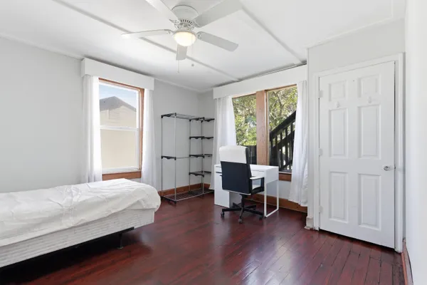 a bedroom with a bed and a chair