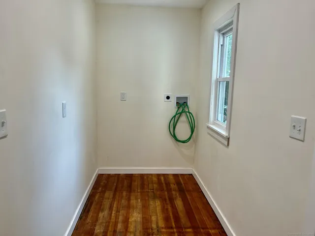 a view of a room with wooden floor and window