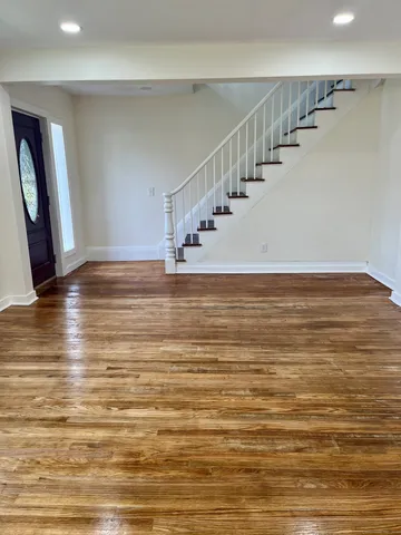 a view of a room with an empty space and stairs