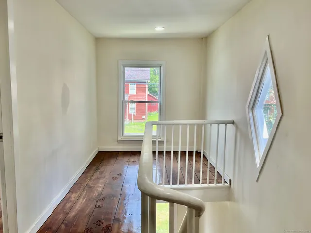 a view of an entryway door with a staircase