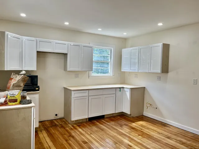 a kitchen with a refrigerator and a stove top oven