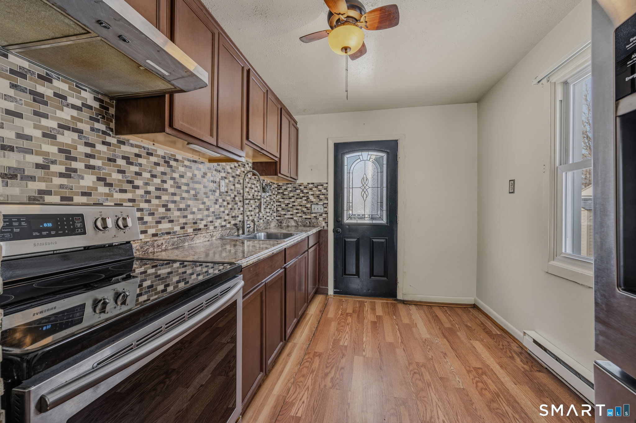 209 Midway Ovl Groton, CT 06340 - Photo 14 of 31 a kitchen with stainless steel appliances granite countertop a stove and a refrigerator