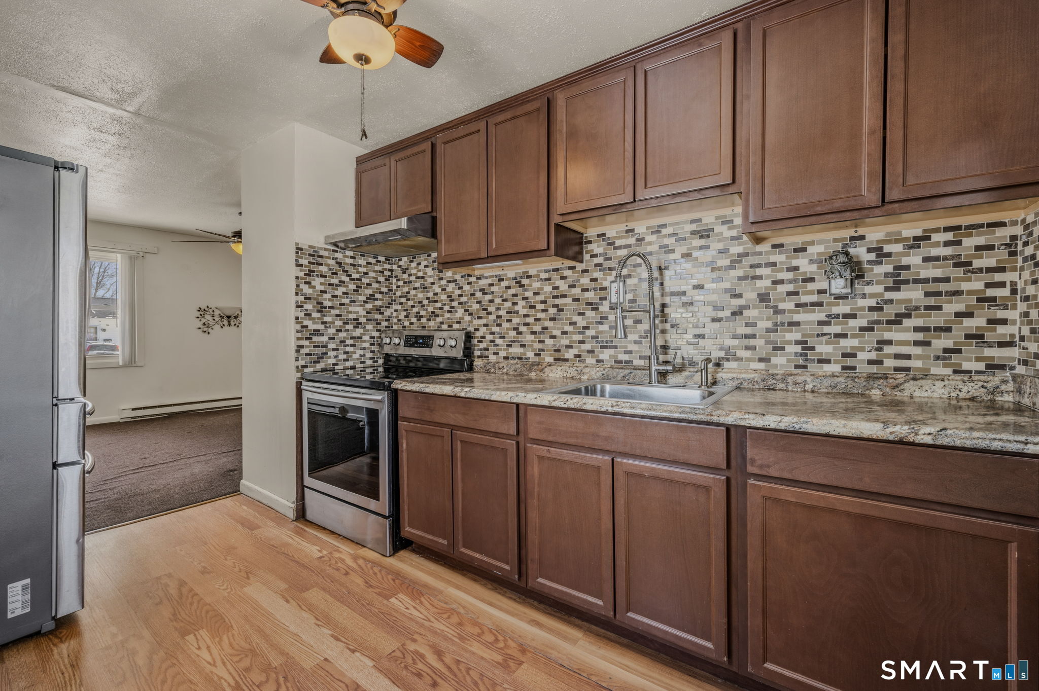 209 Midway Ovl Groton, CT 06340 - Photo 15 of 31 a kitchen with stainless steel appliances granite countertop a sink and cabinets
