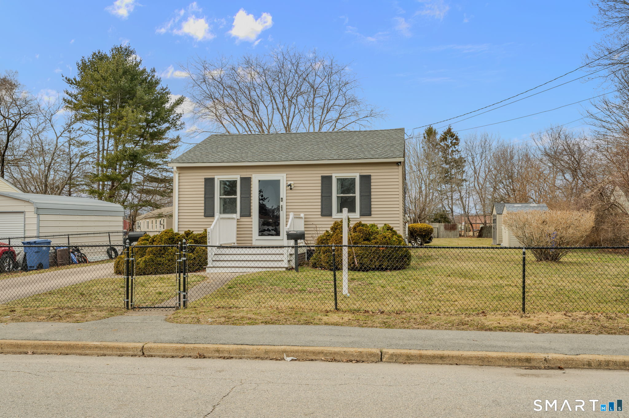 209 Midway Ovl Groton, CT 06340 - Photo 4 of 31 a front view of a house with garden and porch