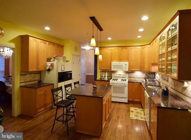 a kitchen with a table chairs refrigerator and sink