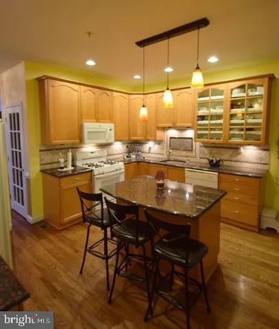 a kitchen with a table chairs and refrigerator