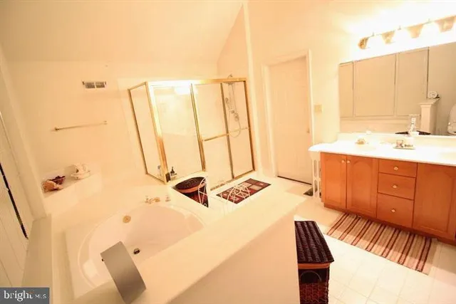 a bathroom with a double vanity sink and a mirror