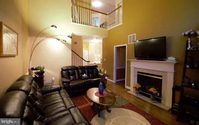 a living room with furniture fireplace and flat screen tv