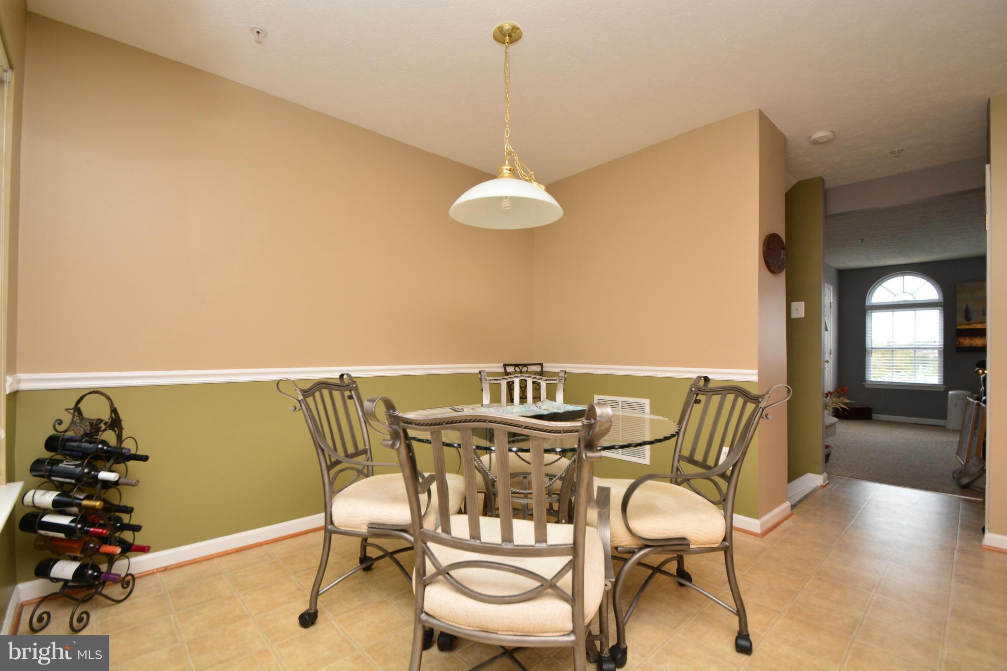9705 Selfridge Road Baltimore, MD 21220 - Photo 11 of 30 a view of a dining room with furniture window and wooden floor