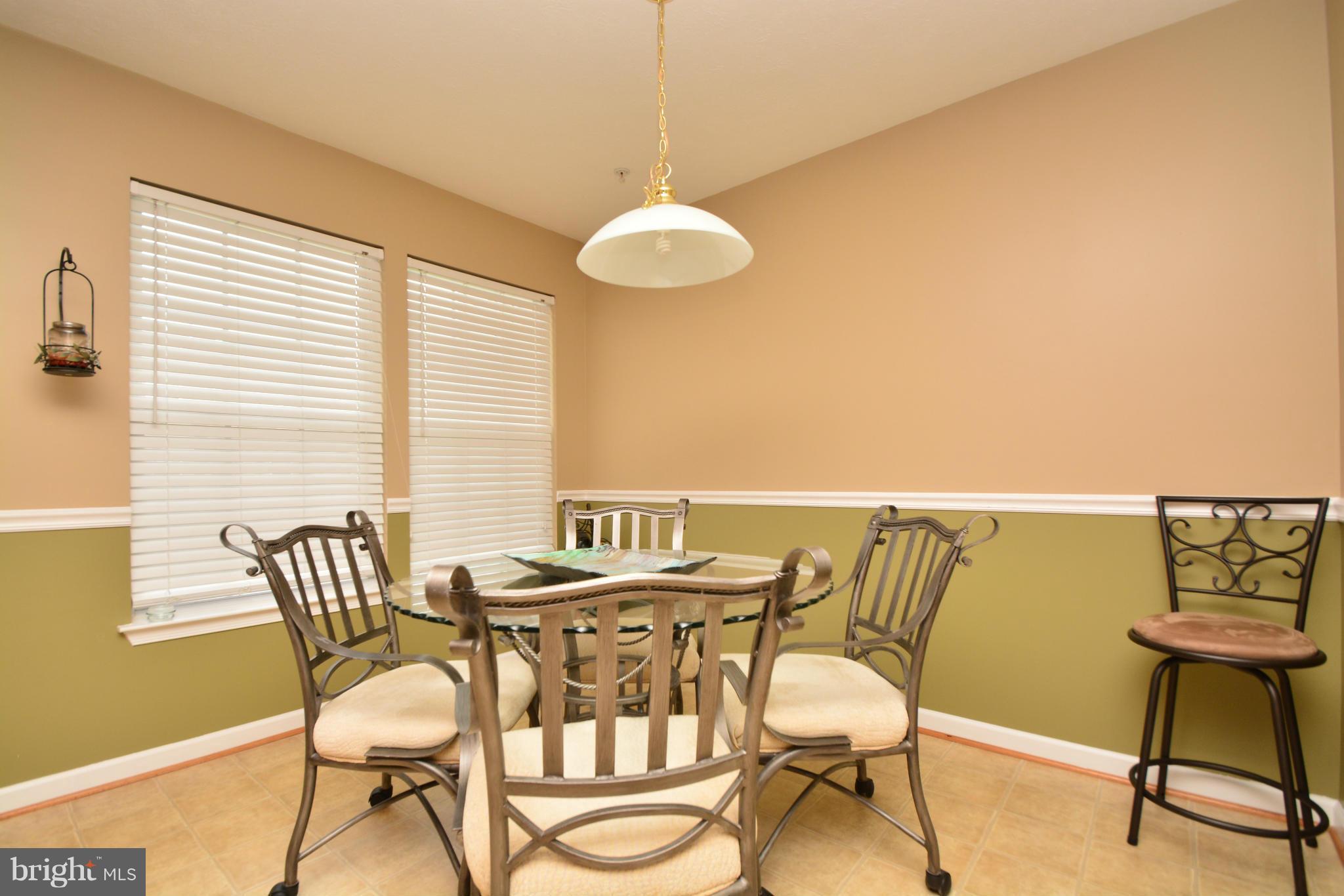 9705 Selfridge Road Baltimore, MD 21220 - Photo 12 of 30 a view of a dining room with furniture and wooden floor