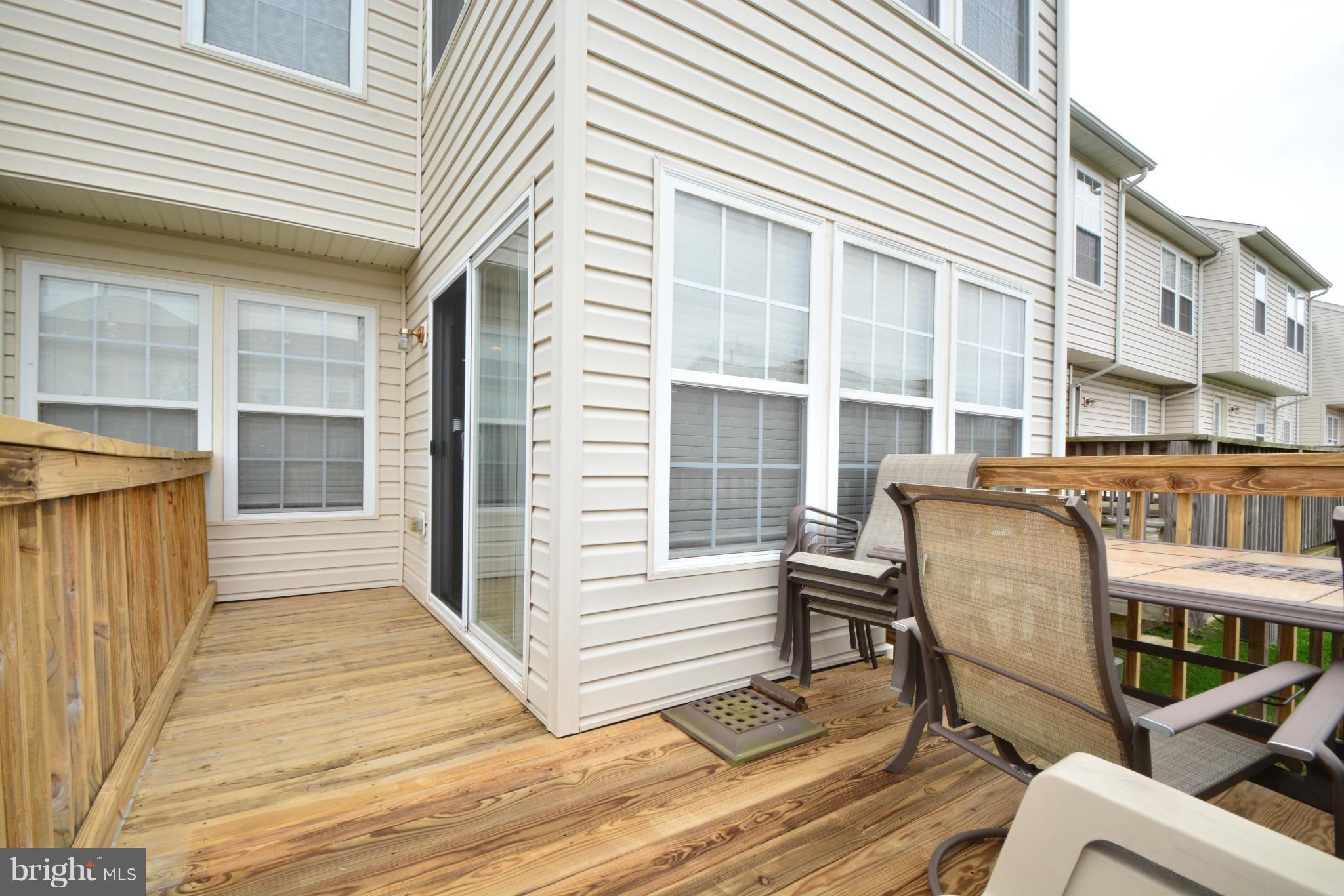 9705 Selfridge Road Baltimore, MD 21220 - Photo 15 of 30 a view of a chair and table on the wooden deck