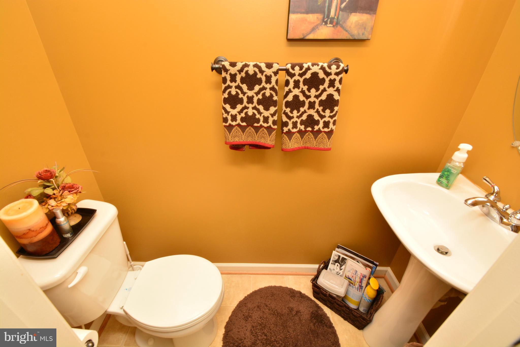 9705 Selfridge Road Baltimore, MD 21220 - Photo 20 of 30 a bathroom with a toilet sink and mirror