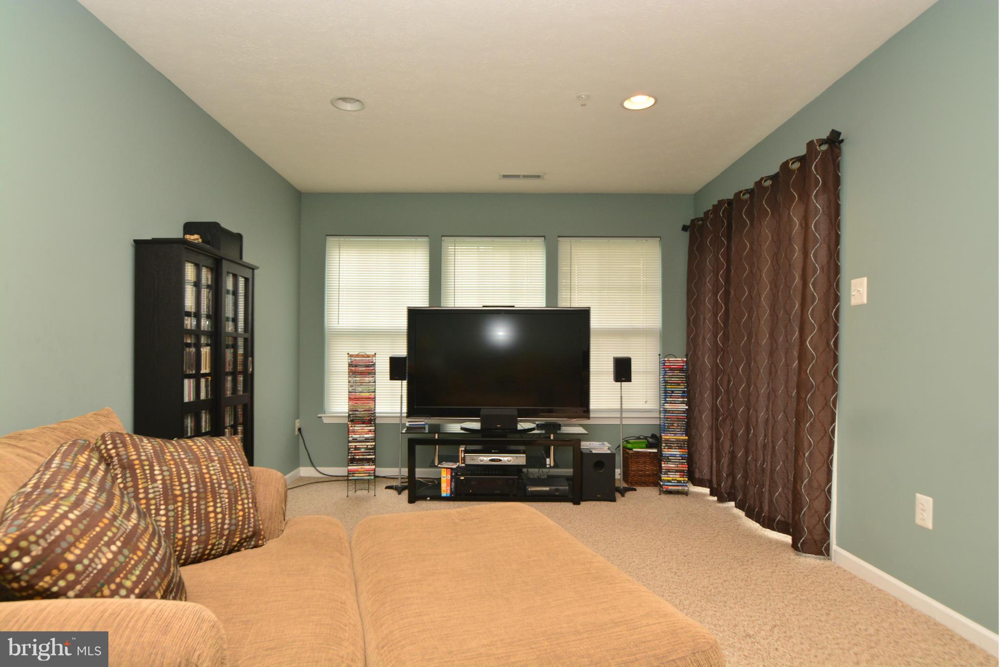 9705 Selfridge Road Baltimore, MD 21220 - Photo 3 of 30 a bedroom with a bed and a flat screen tv