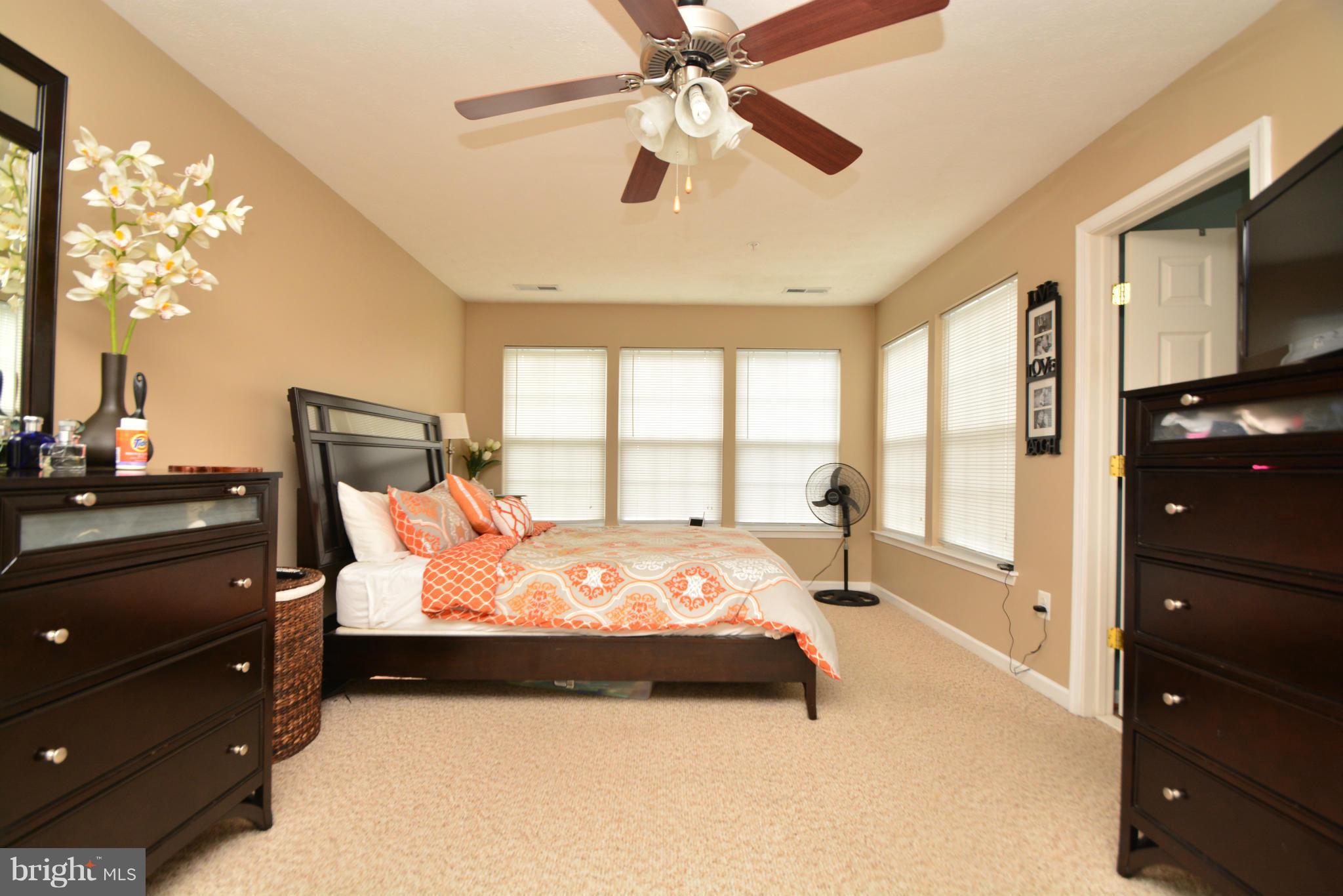 9705 Selfridge Road Baltimore, MD 21220 - Photo 21 of 30 a bedroom with a bed a window and a chandelier