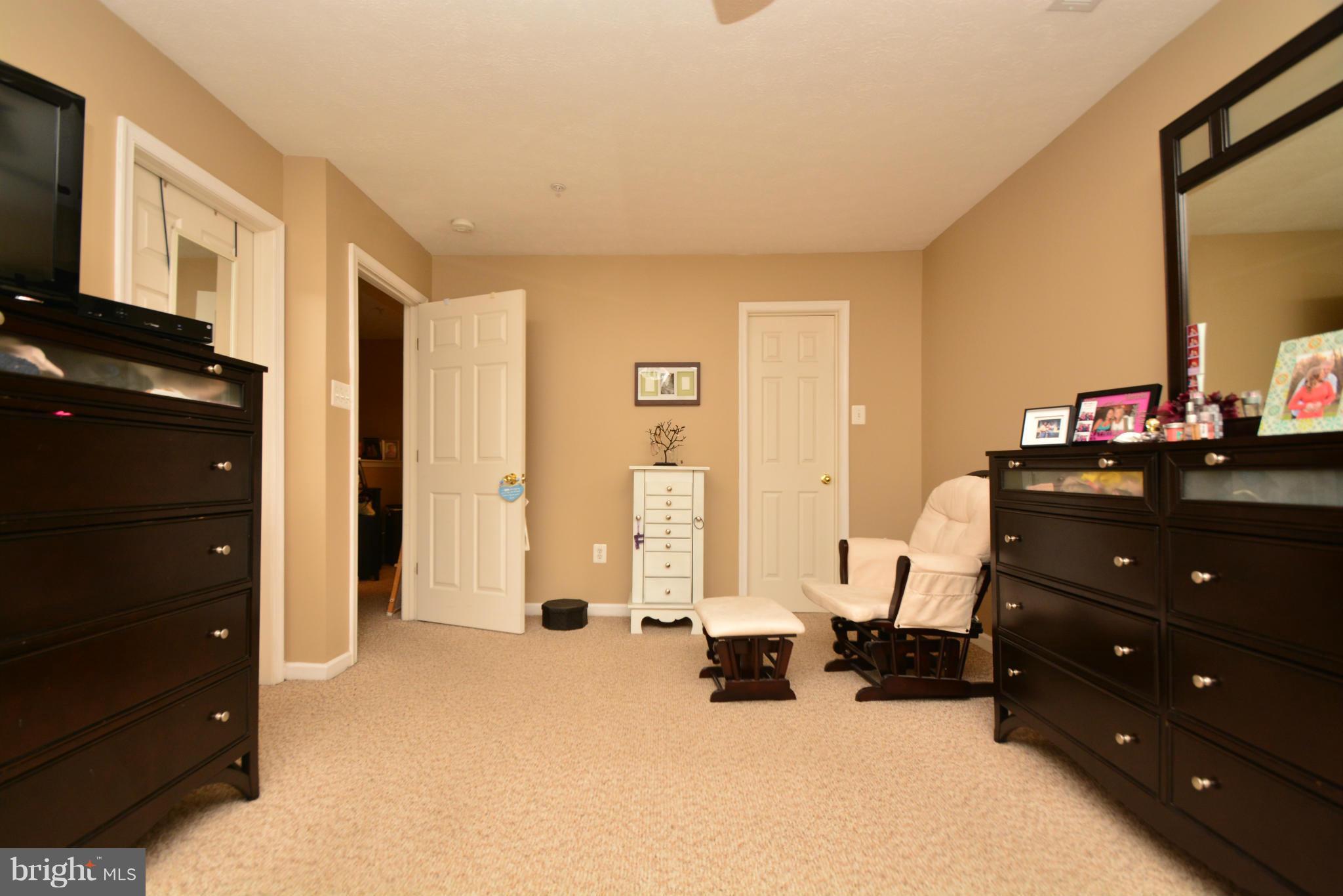 9705 Selfridge Road Baltimore, MD 21220 - Photo 23 of 30 a bedroom with furniture and a mirror