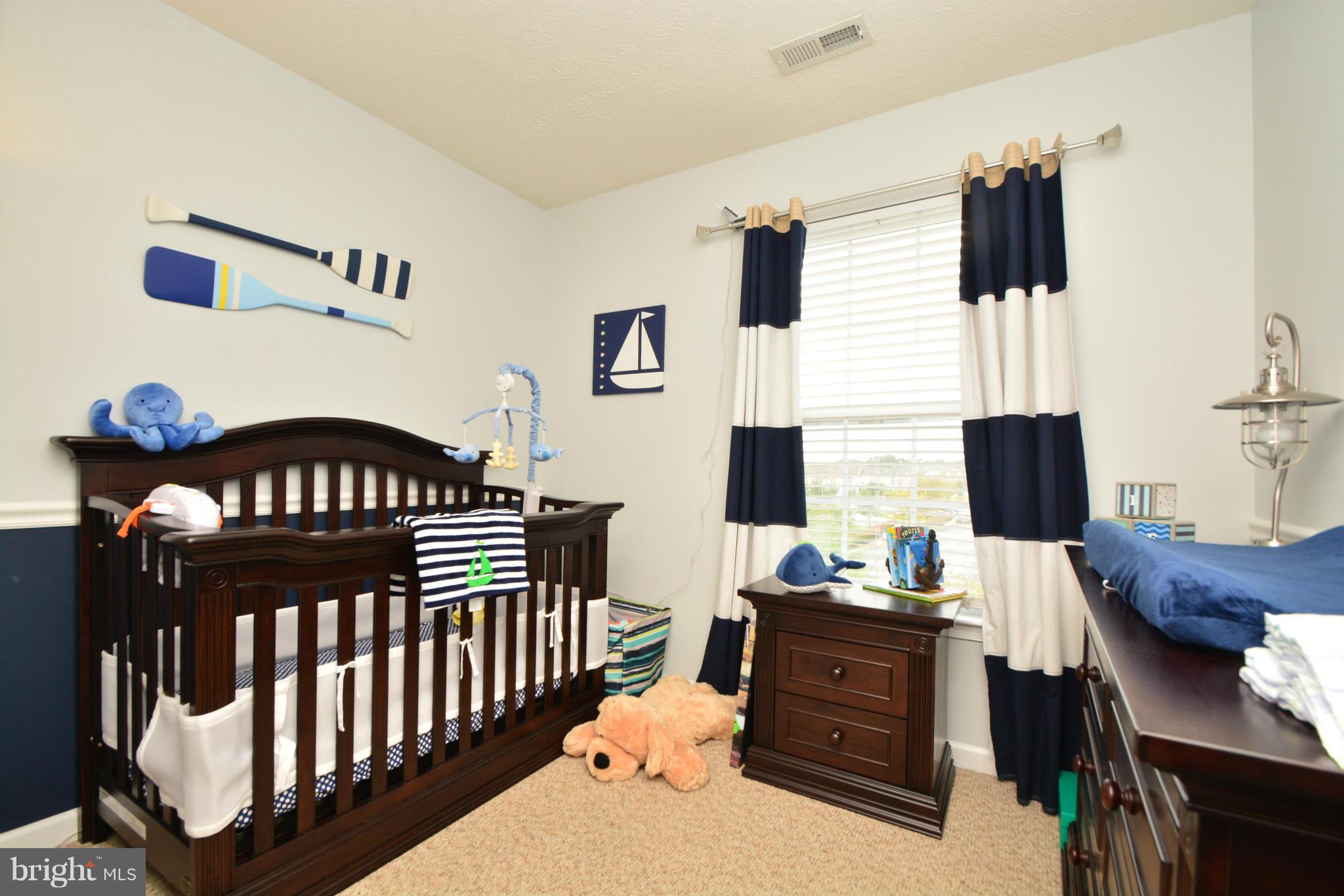 9705 Selfridge Road Baltimore, MD 21220 - Photo 27 of 30 a bedroom with a bed and wooden floor