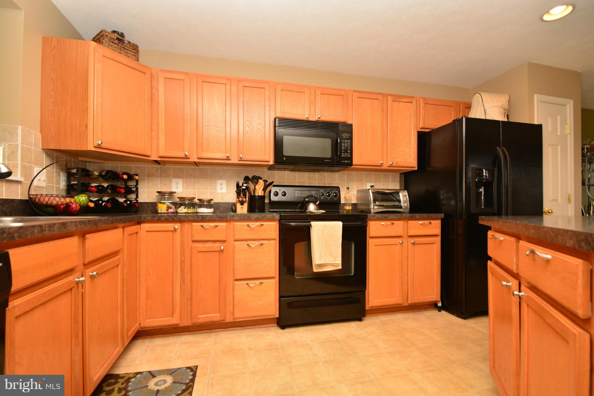 9705 Selfridge Road Baltimore, MD 21220 - Photo 7 of 30 a kitchen with stainless steel appliances a refrigerator sink and microwave