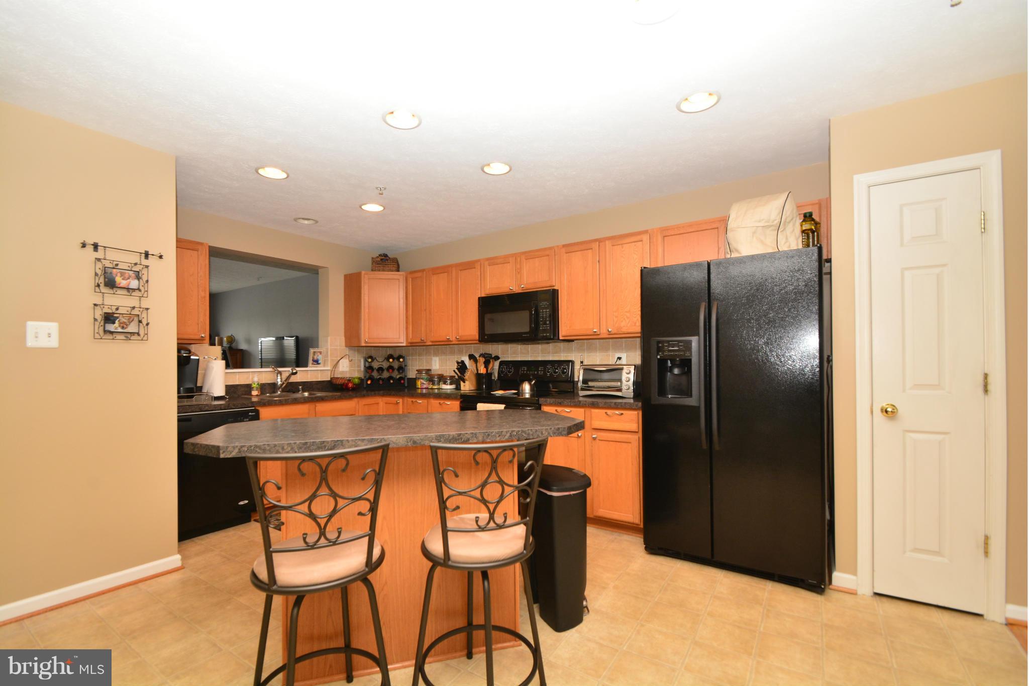 9705 Selfridge Road Baltimore, MD 21220 - Photo 8 of 30 a kitchen with stainless steel appliances granite countertop a refrigerator and a stove top oven
