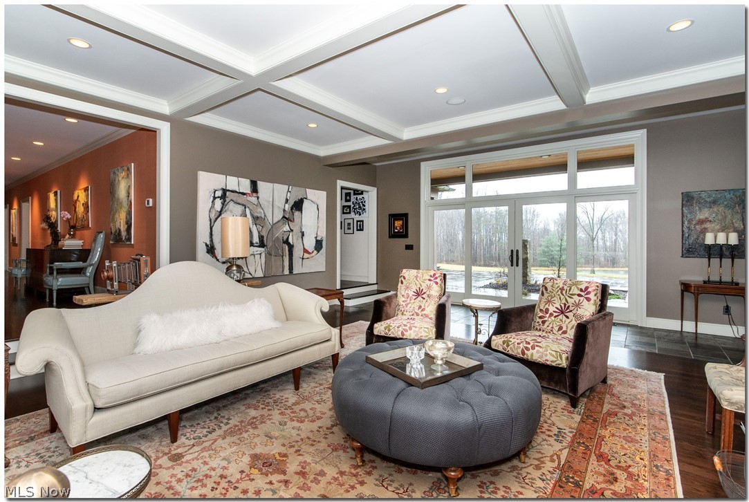 The great room flows seamlessly from the foyer hallway and out to the stone patio.