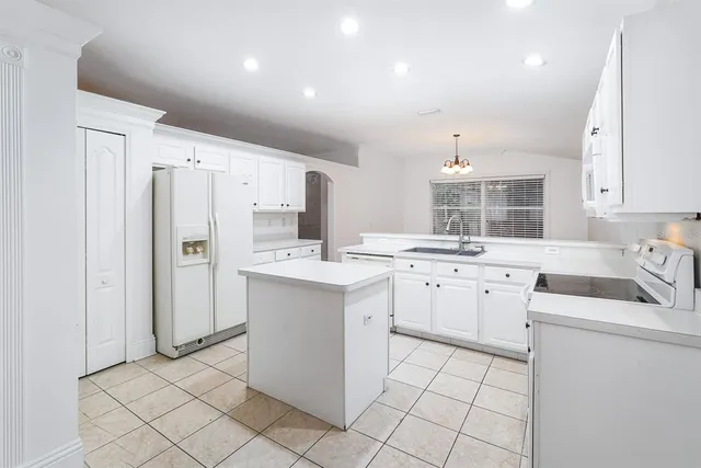 a view of an empty room with a window and a ceiling fan