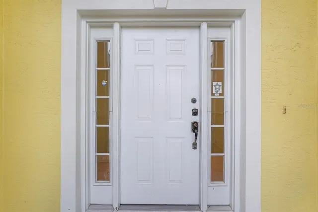 a view of a hallway with wooden floor and a living room