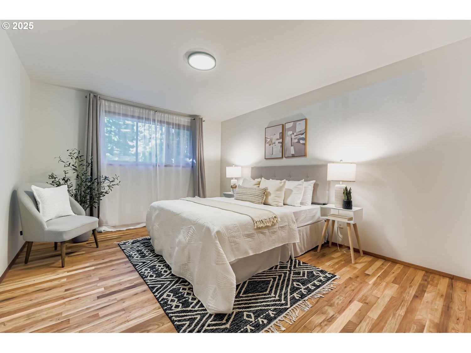 2728 Southeast 175th Place Portland, OR 97236 - Photo 13 of 33 a bedroom with a bed and wooden floor