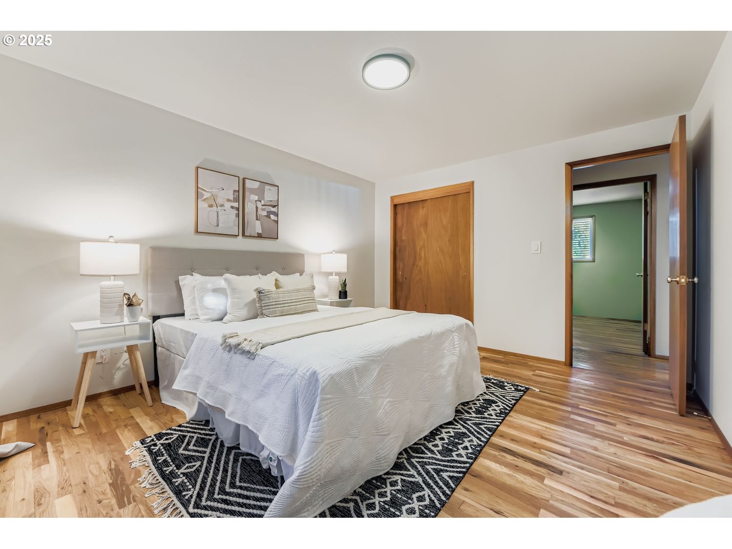 2728 Southeast 175th Place Portland, OR 97236 - Photo 14 of 33 a bedroom with a bed and a wooden floor