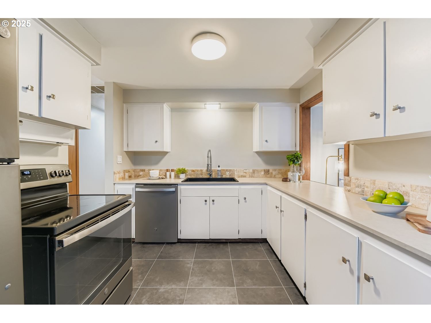 2728 Southeast 175th Place Portland, OR 97236 - Photo 7 of 33 a kitchen with a sink dishwasher stove and white cabinets