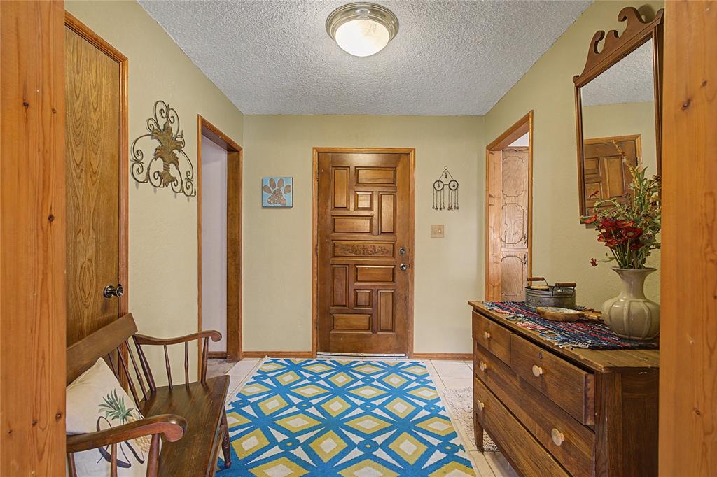 243 County Road 3851 Poolville, TX 76487 - Photo 6 of 34 a bedroom with a bed and wooden floor